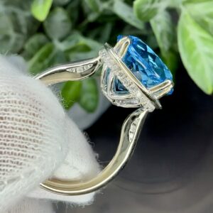 18k White Gold Ring w/ 13mm Swiss Blue Topaz & Hidden Halo Diamonds. Size 6 1/2. 7.9 grams.