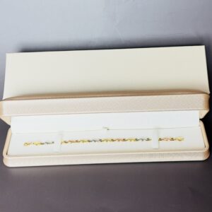 10K Yellow, White and Rose Gold Tri tone Bracelet. Ladies Link Cross Ribbon style with Lobster Clasp. 7" long. 4.75mm wide. 3.4 Grams